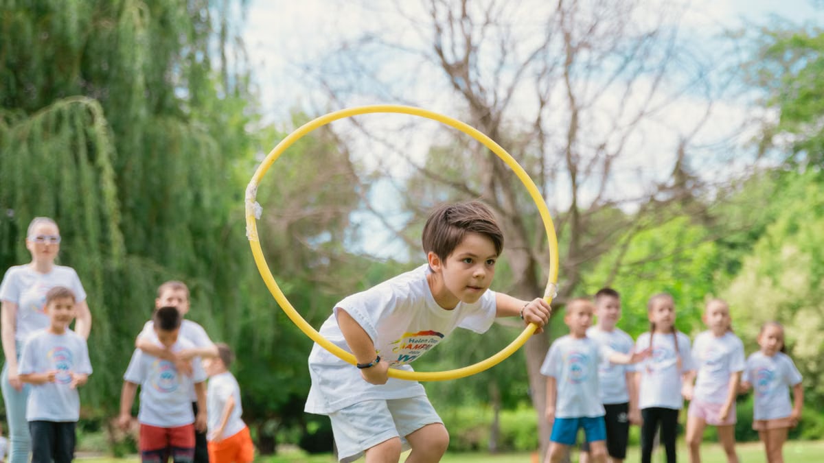 Kids enjoying a summer day playing with hula hoops in a park, showcasing friendship and fun.